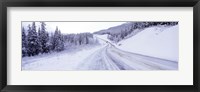 Framed Snow covered road in winter, Haines Highway, Yukon, Canada