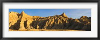 Framed Sculpted sandstone spires in golden light, Saddle Pass Trail, Badlands National Park, South Dakota, USA