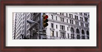 Framed Low angle view of a Red traffic light in front of a building, Wall Street, New York City