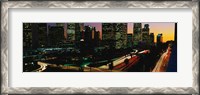Framed Harbor Freeway and buildings lit up, Los Angeles CA
