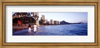 Framed Rear view of a couple wading on the beach, Waikiki Beach, Honolulu, Oahu, Hawaii, USA