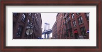 Framed Low angle view of a suspension bridge viewed through buildings, Manhattan Bridge, Brooklyn, New York City, New York State, USA
