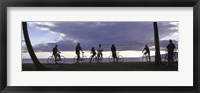 Framed Tourists cycling on the beach, Honolulu, Oahu, Hawaii, USA