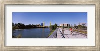 Framed Bicyclists along the Sacramento River with Tower Bridge in background, Sacramento, Sacramento County, California, USA