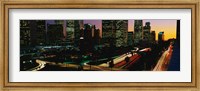 Framed Harbor Freeway and buildings lit up, Los Angeles CA