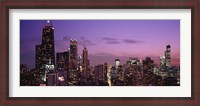 Framed Chicago Buildings lit up at dusk