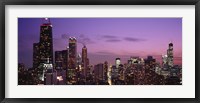 Framed Chicago Buildings lit up at dusk