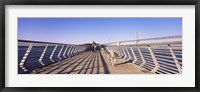 Framed Couple walking on a pier, Bay Bridge, San Francisco, California, USA