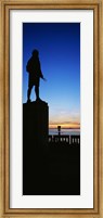 Framed Captain Cook monument silhouetted by sunset, Anchorage, Alaska, USA.