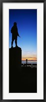 Framed Captain Cook monument silhouetted by sunset, Anchorage, Alaska, USA.