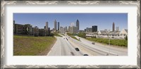 Framed Vehicles moving on the road leading towards the city, Atlanta, Georgia, USA