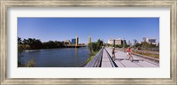 Framed Bicyclists along the Sacramento River with Tower Bridge in background, Sacramento, Sacramento County, California, USA