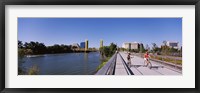 Framed Bicyclists along the Sacramento River with Tower Bridge in background, Sacramento, Sacramento County, California, USA