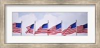 Framed Low angle view of American flags fluttering in wind