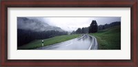 Framed Wet highway passing through a forest, Austria