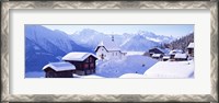 Framed Snow Covered Chapel and Chalets Swiss Alps Switzerland