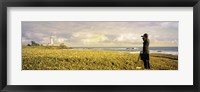 Framed USA, California, Businessman standing holding binoculars and looking at the lighthouse