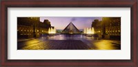 Framed Museum lit up at night with ghosted image of three men, Louvre Museum, Paris, France