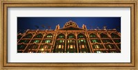 Framed Low angle view of a building lit up at night, Harrods, London, England