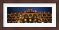 Framed Low angle view of a building lit up at night, Harrods, London, England