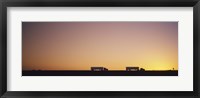 Framed Silhouette of two trucks moving on a highway, Interstate 5, California, USA