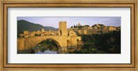 Framed Arch bridge across a river in front of a city, Besalu, Catalonia, Spain