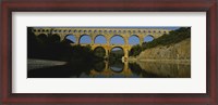 Framed Reflection of an arch bridge in a river, Pont Du Gard, France
