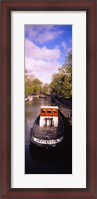 Framed Tourboat docked in a channel, Amsterdam, Netherlands