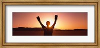 Framed Silhouette of a person wearing boxing gloves in a desert at dusk, Black Rock Desert, Nevada, USA