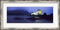 Framed Castle lit up at dusk, Eilean Donan Castle, Loch Duich, Dornie, Highlands Region, Scotland