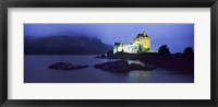 Framed Castle lit up at dusk, Eilean Donan Castle, Loch Duich, Dornie, Highlands Region, Scotland