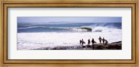 Framed Silhouette of surfers standing on the beach, Australia