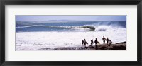 Framed Silhouette of surfers standing on the beach, Australia