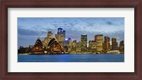 Framed Opera house and buildings lit up at dusk, Sydney Opera House, Sydney Harbor, Sydney, New South Wales, Australia
