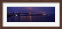Framed Suspension bridge lit up at dawn viewed from fishing pier, Golden Gate Bridge, San Francisco Bay, San Francisco, California, USA