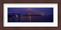 Framed Suspension bridge lit up at dawn viewed from fishing pier, Golden Gate Bridge, San Francisco Bay, San Francisco, California, USA