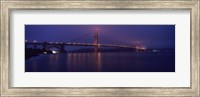 Framed Suspension bridge lit up at dawn viewed from fishing pier, Golden Gate Bridge, San Francisco Bay, San Francisco, California, USA