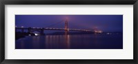 Framed Suspension bridge lit up at dawn viewed from fishing pier, Golden Gate Bridge, San Francisco Bay, San Francisco, California, USA