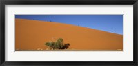 Framed Tourists climbing up a sand dune, Dune 45, Sossusvlei, Namib Desert, Namibia
