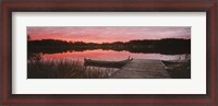 Framed Canoe tied to dock on a small lake at sunset, Sweden