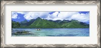 Framed Polynesian people rowing a yellow outrigger boat in the bay, Opunohu Bay, Moorea, Tahiti, French Polynesia