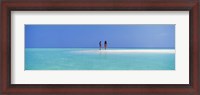 Framed Two women standing on the beach sandbar, Maayafushi Island, Ari Atoll, Maldives