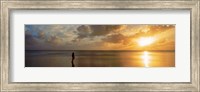 Framed Woman standing on sandbar looking at sunset, Aitutaki, Cook Islands