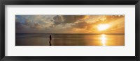 Framed Woman standing on sandbar looking at sunset, Aitutaki, Cook Islands