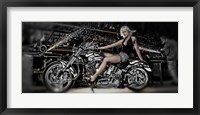 Framed Female model with a motorcycle in a workshop