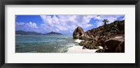 Framed Rock formations on the beach on Anse Source d'Argent beach with Praslin Island in the background, La Digue Island, Seychelles