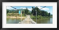 Framed Old wooden bridge across the river, Chiang Mai Province, Thailand