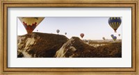 Framed Hot air balloons soaring over a mountain ridge, Cappadocia, Central Anatolia Region, Turkey