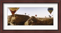 Framed Hot air balloons soaring over a mountain ridge, Cappadocia, Central Anatolia Region, Turkey