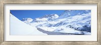 Framed Snow covered mountains on both sides of a road, St Moritz, Graubunden, Switzerland